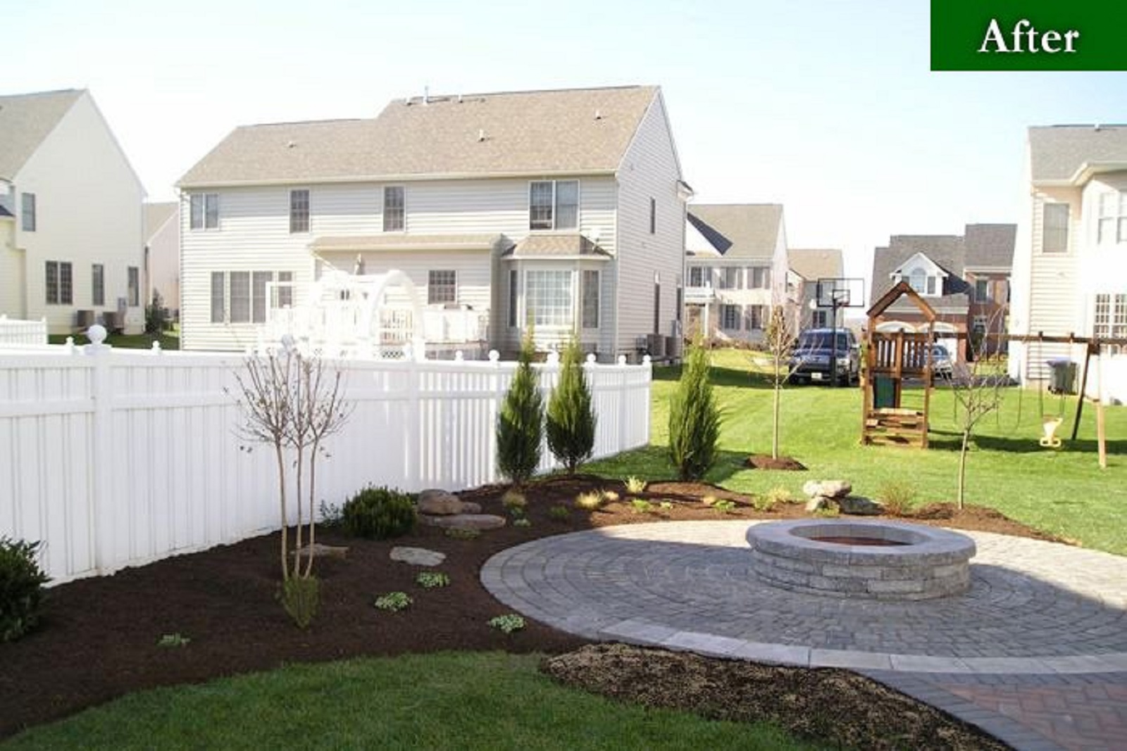 Back yard after a landscape design project of fire pit and stone heater