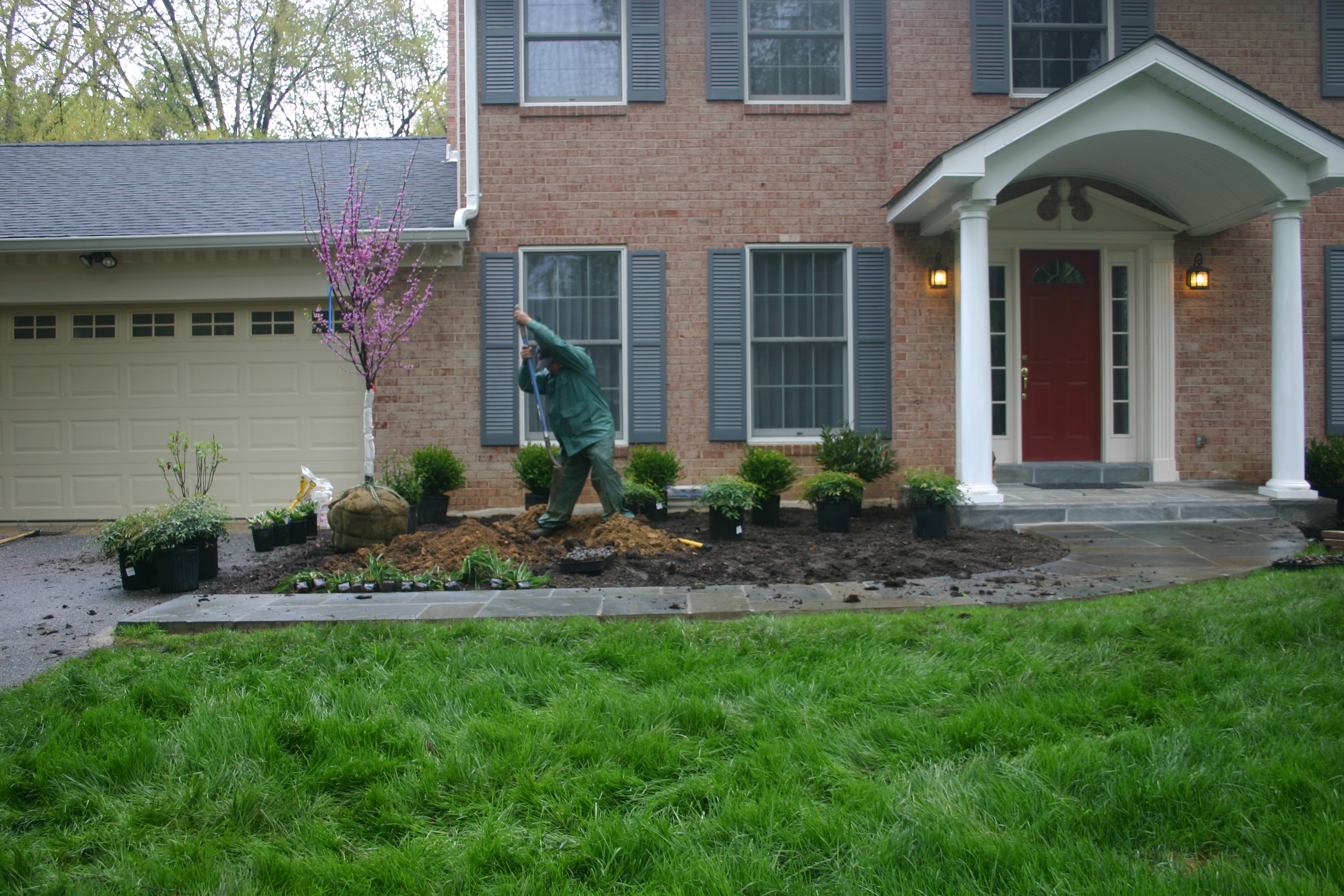 Men working in a front yard Potomac, MD, USA