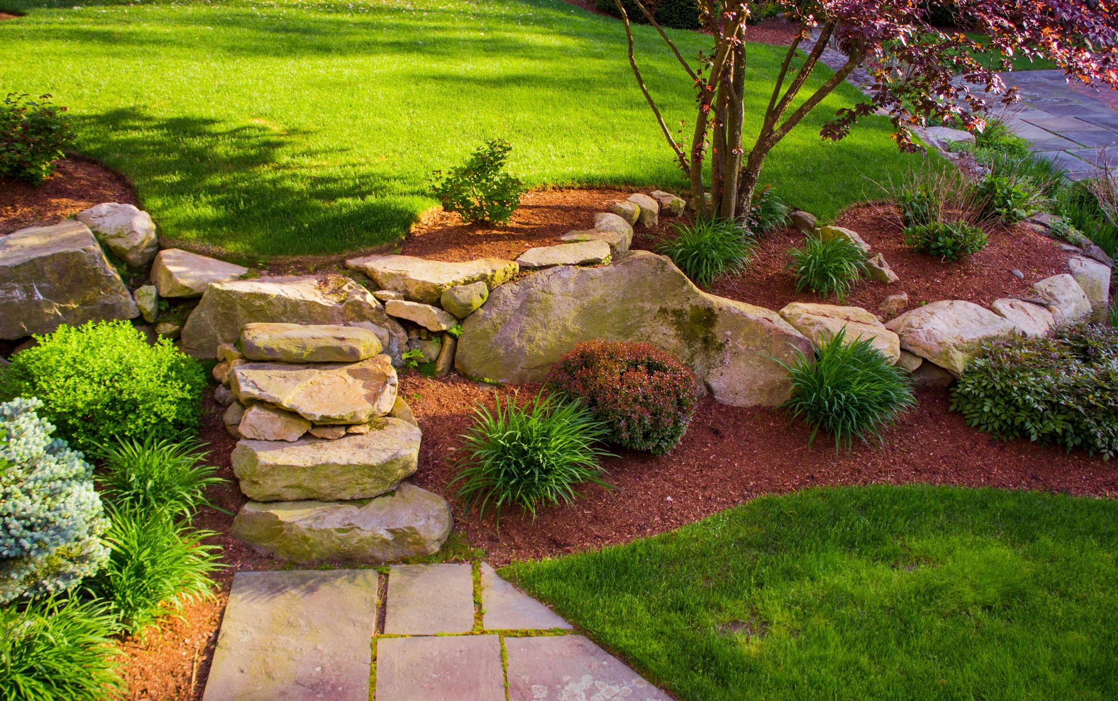 Stone pathway and staircase leading to beautiful lawn